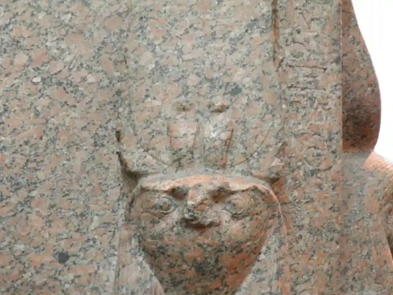 Sculpture of king Thutmose III, falcon-headed god, two uraei